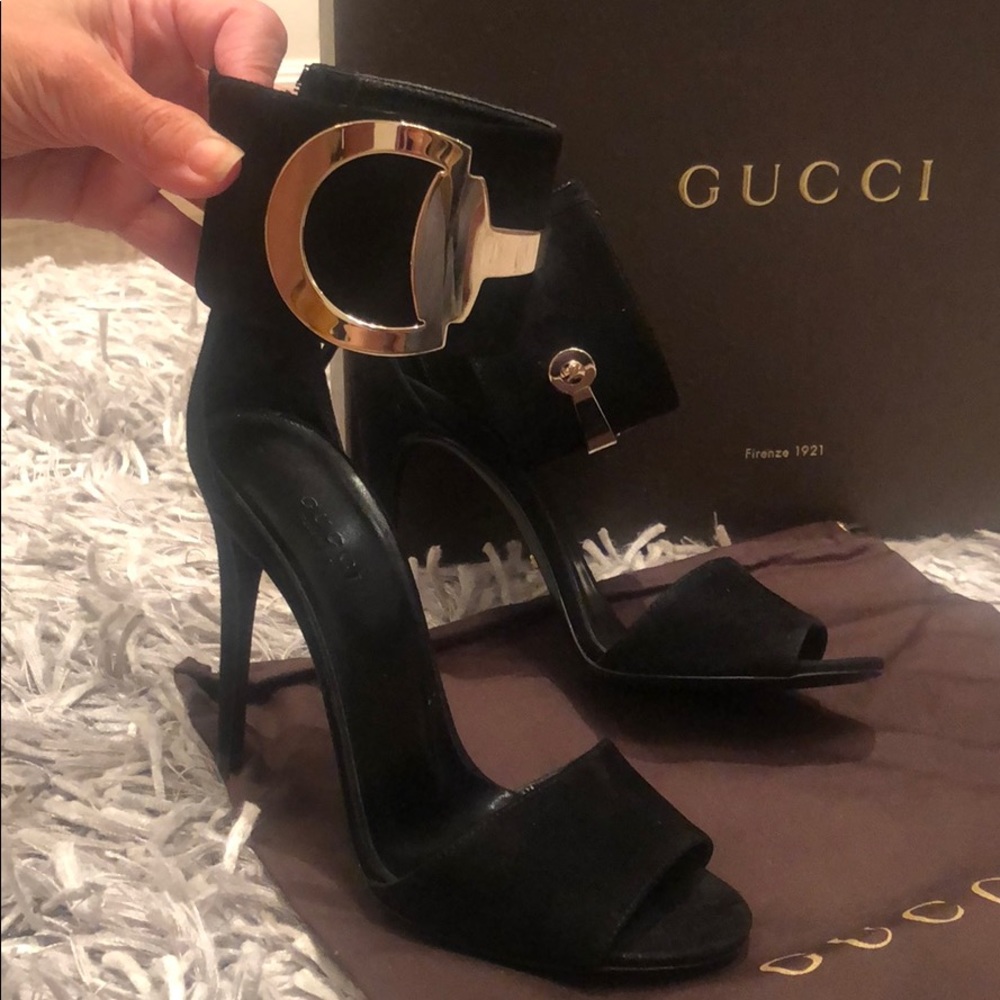 Gucci black suede heels with gold buckle.